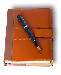 Image showing Fountain pen on top of the closed notebook