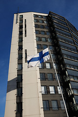 Image showing fluttering national flag of Finland beside modern building