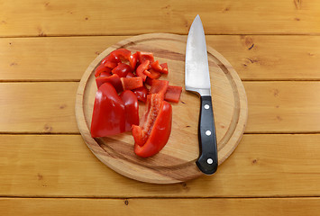 Image showing Red pepper sliced with knife on a chopping board