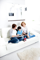 Image showing Portrait of friendly family reading book