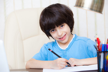 Image showing child doing homework with computer, portrait