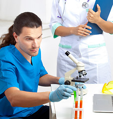 Image showing researcher takes test tube in a laboratory