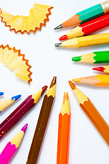 Image showing several colored pencils and shavings on white background