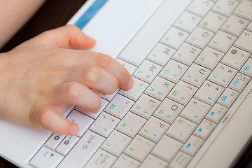 Image showing child\'s hand on the laptop keyboard