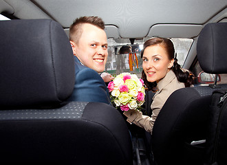 Image showing bride and groom in a car