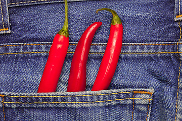 Image showing chili peppers in a jeans pocket