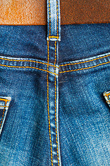 Image showing ol blue denim with seams and leather belt 