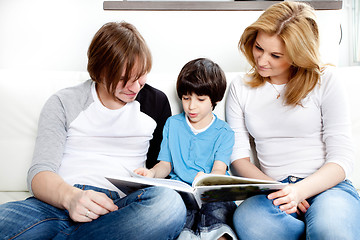 Image showing Portrait of friendly family reading book