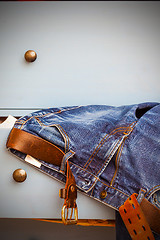 Image showing jeans sticking out of a drawer