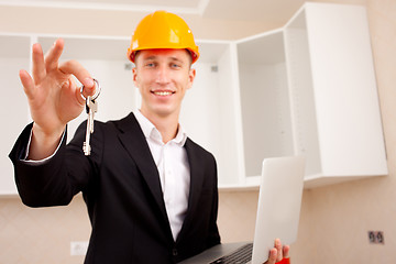 Image showing civil engineer with a laptop gives the keys