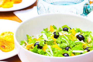 Image showing Assorted salad of green leaf lettuce with squid and black olives
