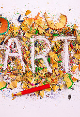 Image showing art word on the background of colored pencil shavings