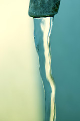Image showing Tap of running water isolated on grey background