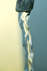 Image showing Tap of running water isolated on grey background