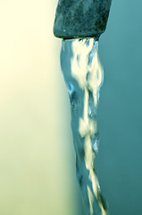 Image showing Tap of running water isolated on grey background