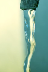 Image showing Tap of running water isolated on grey background