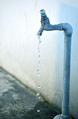 Image showing Tap of running water isolated on grey background