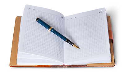 Image showing Fountain pen on top of the open notebook