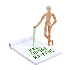 Image showing Wooden mannequin writing in scrapbook - Make things happen