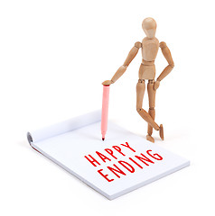 Image showing Wooden mannequin writing in scrapbook - Happy ending