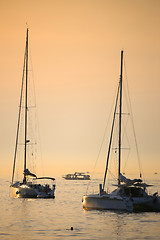 Image showing Anchored boats at sunset