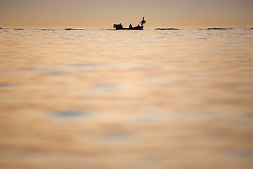 Image showing Boat sailing at sunset