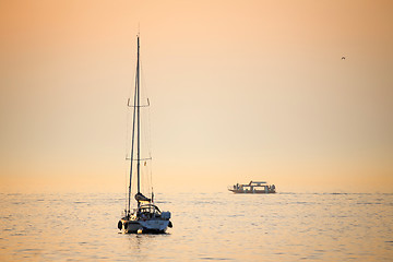 Image showing Boats in sea at sunset