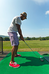 Image showing Golfer Teeing Up at the Driving Range