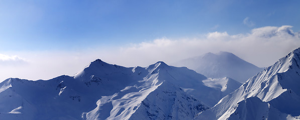 Image showing Panorama of snowy mountains in early morning fog