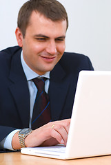 Image showing Young businessman working on a lap-top