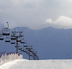 Image showing Snow skiing piste and ropeway at evening