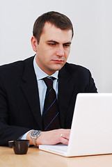 Image showing Serious businessman working on lap-top