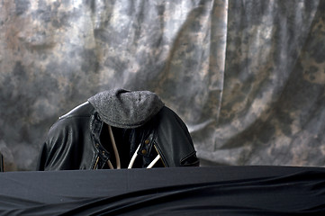 Image showing black leather jacket and cap