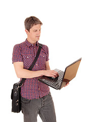 Image showing Standing man with laptop.