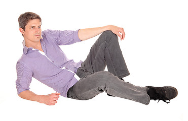 Image showing Young man sitting on floor.