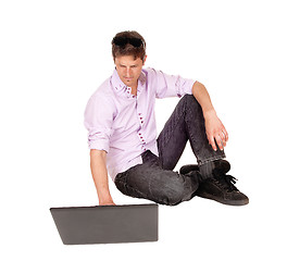 Image showing Man working on laptop of floor.