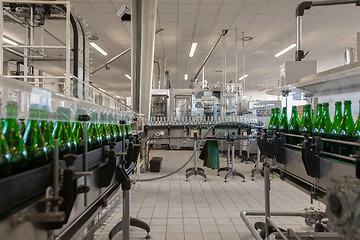 Image showing Many bottles on conveyor belt