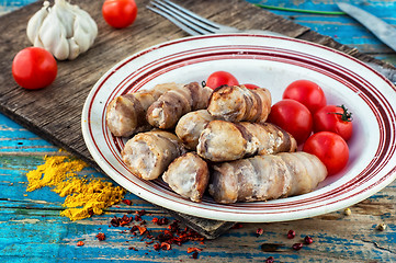 Image showing set fried meat sausages on wooden background