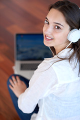 Image showing relaxed young woman at home working on laptop computer