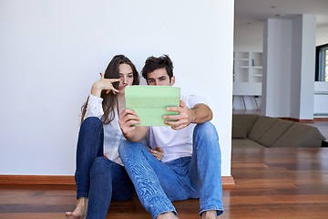 Image showing couple at modern home using tablet computer