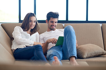 Image showing couple at modern home using tablet computer