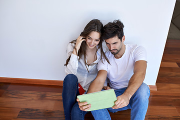 Image showing couple at modern home using tablet computer