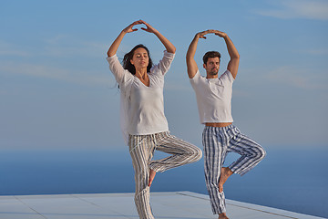Image showing young couple practicing yoga