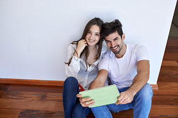 Image showing couple at modern home using tablet computer