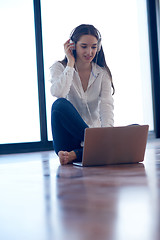 Image showing relaxed young woman at home working on laptop computer