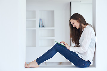 Image showing woman at home using tablet