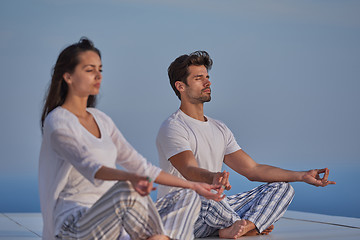 Image showing young couple practicing yoga