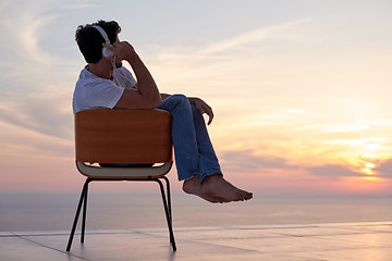 Image showing relaxed young man at home on balcony