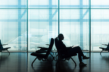 Image showing Woman in transit waiting on airport gate.