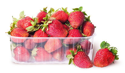 Image showing Freshly strawberries in a plastic tray and two near